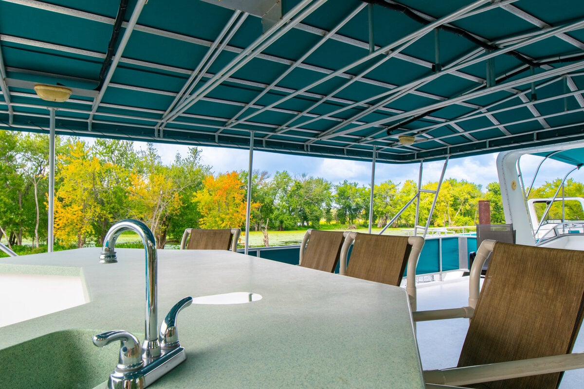 Great River Harbor_Fun n the Sun Houseboats-16 Outdoor boat deck with seating overlooking lush fall foliage in Buffalo County, Wisconsin.