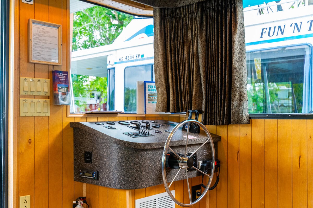 Great River Harbor_Fun n the Sun Houseboats-21 Boat tour control panel with steering wheel and navigational controls at Explore Buffalo County Wisconsin.
