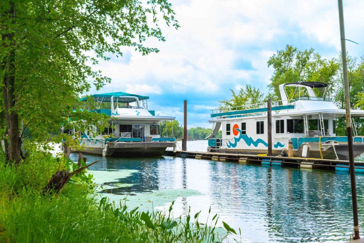 Great River Harbor_Fun n the Sun Houseboats-24 Boats docked on the Eau Claire River in Buffalo County, Wisconsin, surrounded by lush greenery.
